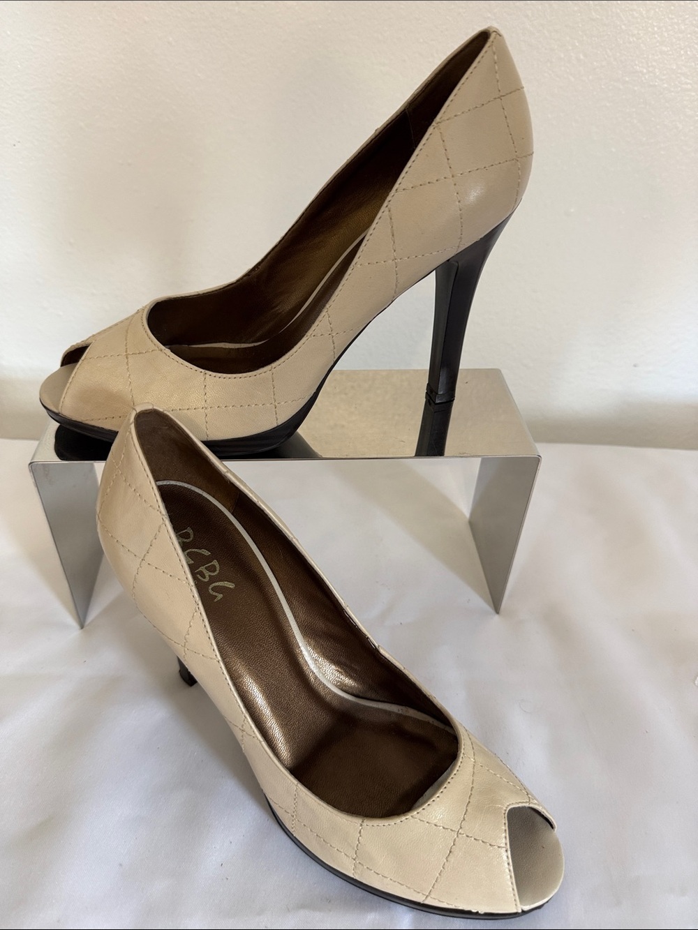 BCBG cream Quilted Peep-Toe leather High Heels available in a size 9.